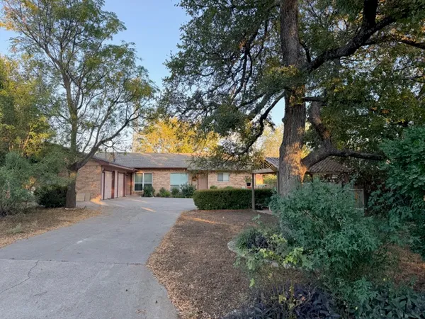 a view of a house with a tree in the background