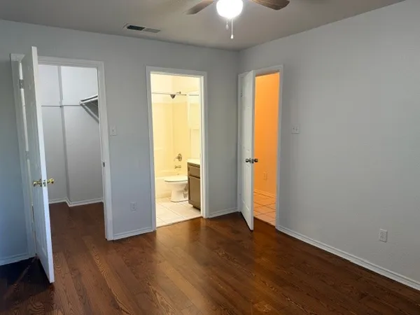 an empty room with wooden floor and a window
