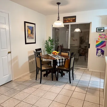 a dining room with furniture and window