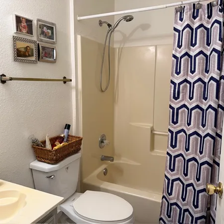 a bathroom with a toilet sink and shower