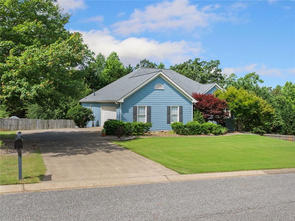 604 Greenleaf Way Ball Ground, GA 30107 - Photo 1 of 1 a front view of a house with a yard and garage