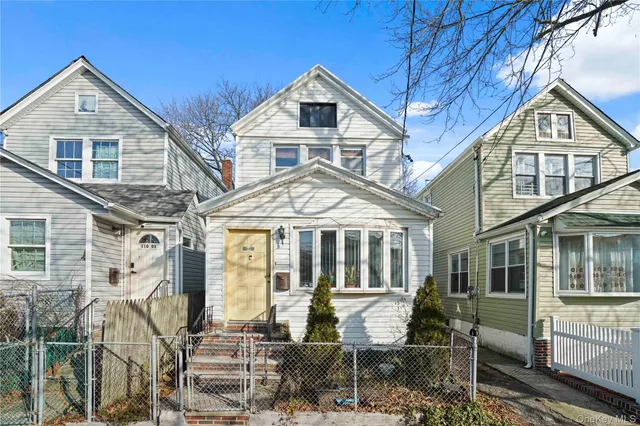 a front view of a house with large windows