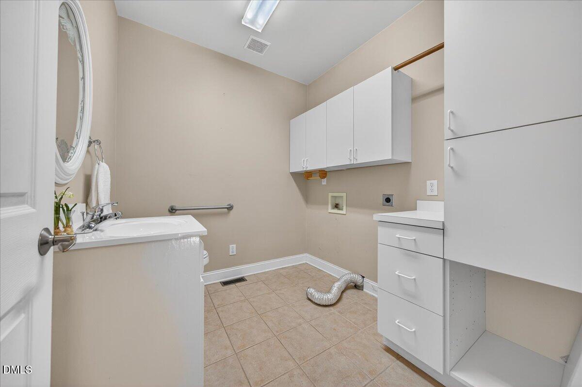 1409 St Patrick Drive Raleigh, NC 27603 - Photo 34 of 53 Main floor laundry wan half bath