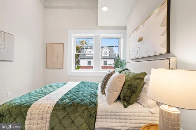 a bedroom with a bed and a painting on the wall