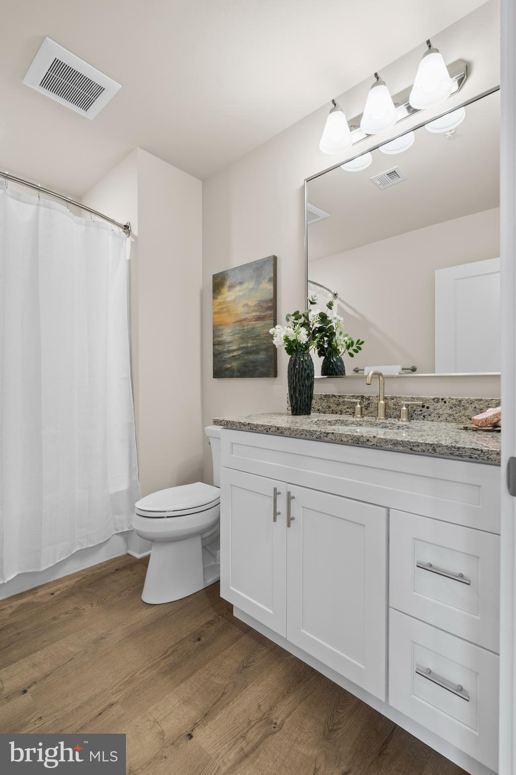 30 West Broad Street Souderton, PA 18964 - Photo 14 of 32 a bathroom with a granite countertop sink toilet and mirror