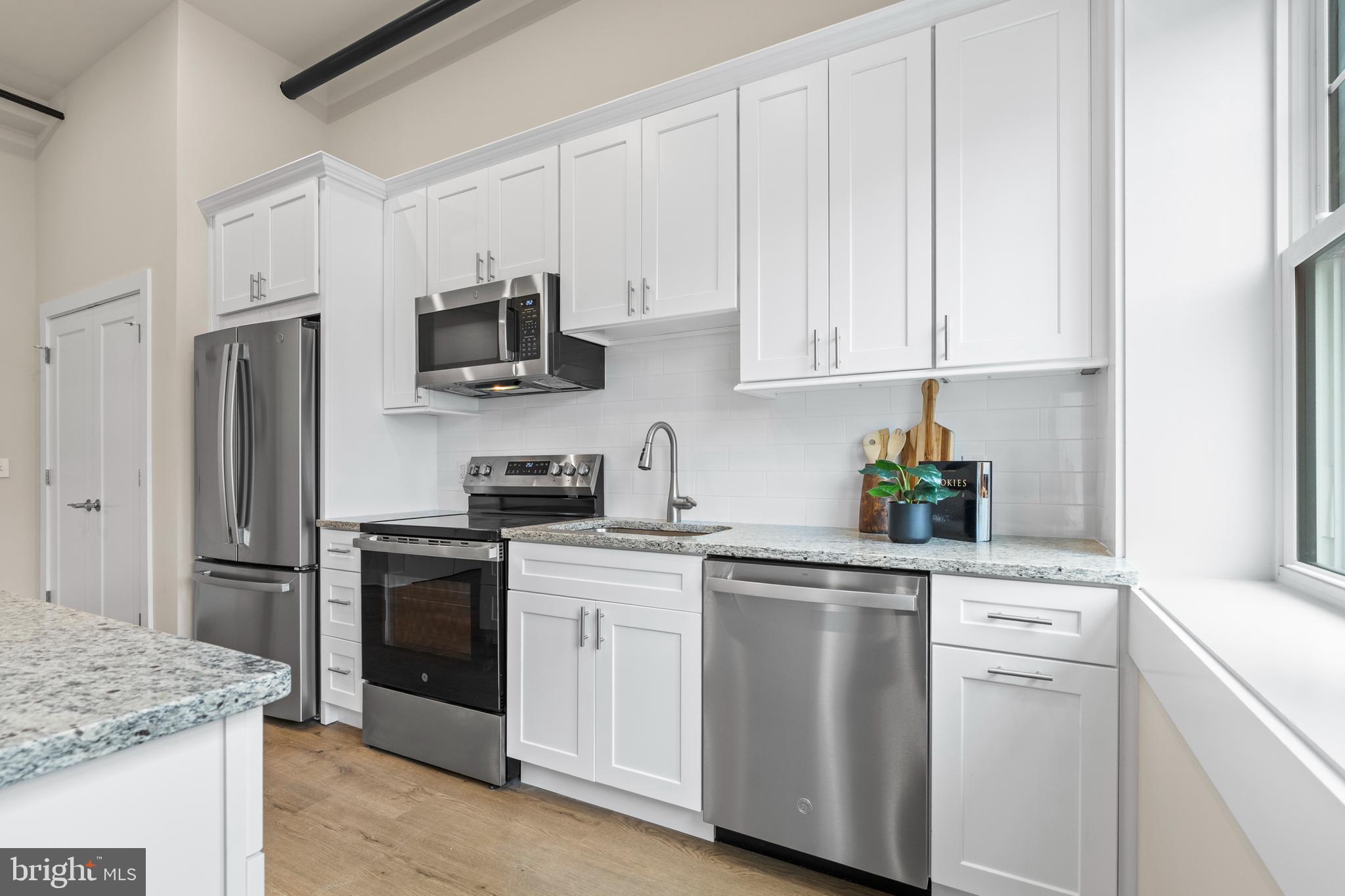 30 West Broad Street Souderton, PA 18964 - Photo 5 of 32 a kitchen with white cabinets and stainless steel appliances