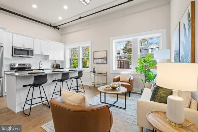 a living room with furniture and a large window