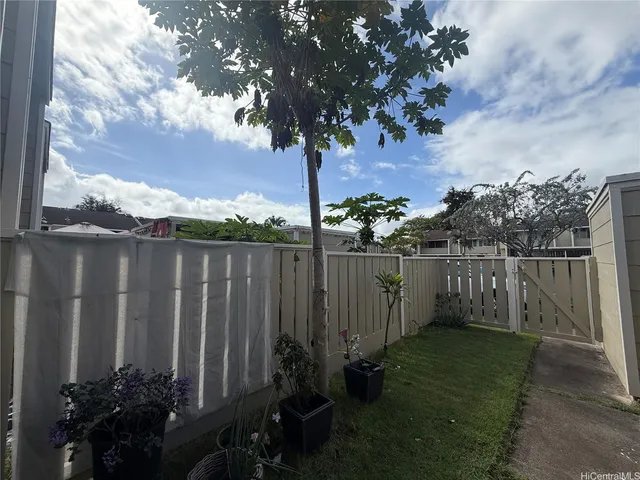 a view of a patio with a table and chairs