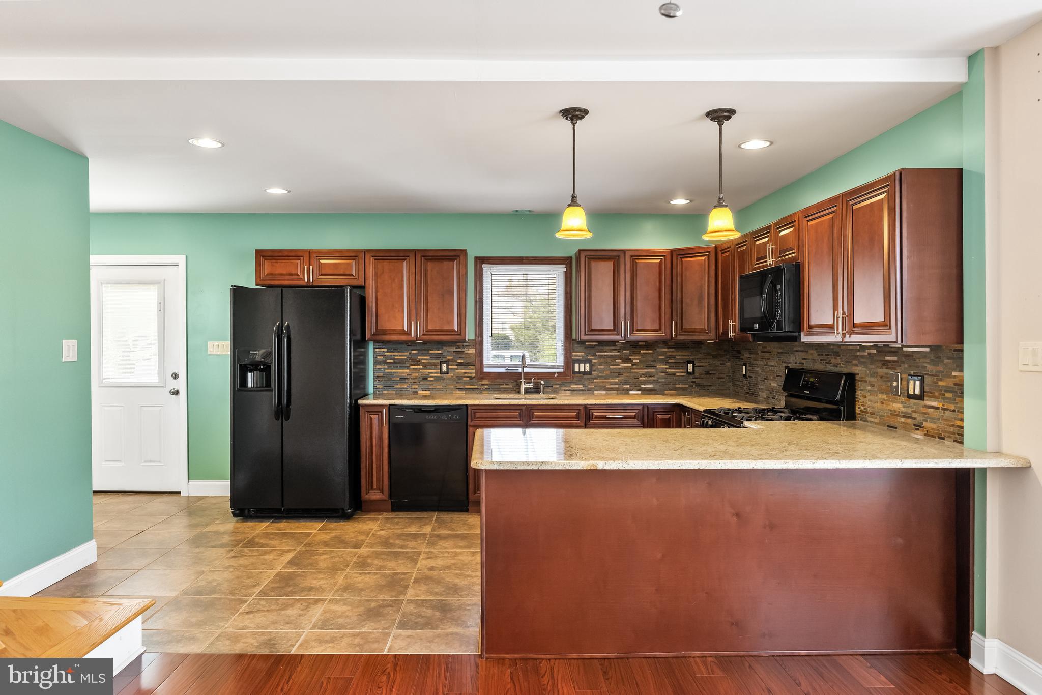 501 West Evesham Road Runnemede, NJ 08078 - Photo 12 of 35 a kitchen with stainless steel appliances granite countertop a refrigerator a sink and a stove