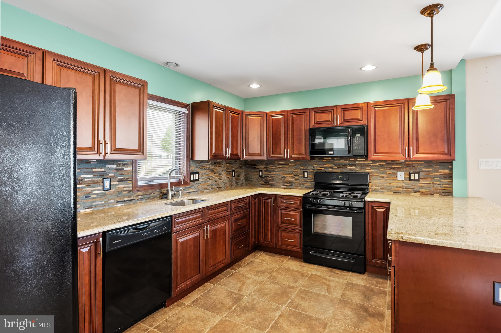 501 West Evesham Road Runnemede, NJ 08078 - Photo 13 of 35 a kitchen with stainless steel appliances granite countertop a stove sink and cabinets