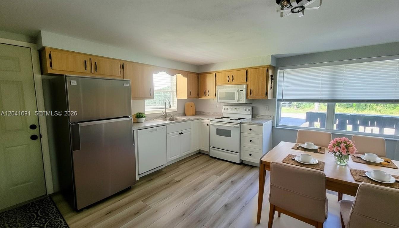 1270 Nobles Road LaBelle, FL 33935 - Photo 6 of 18 a kitchen with a sink appliances and cabinets