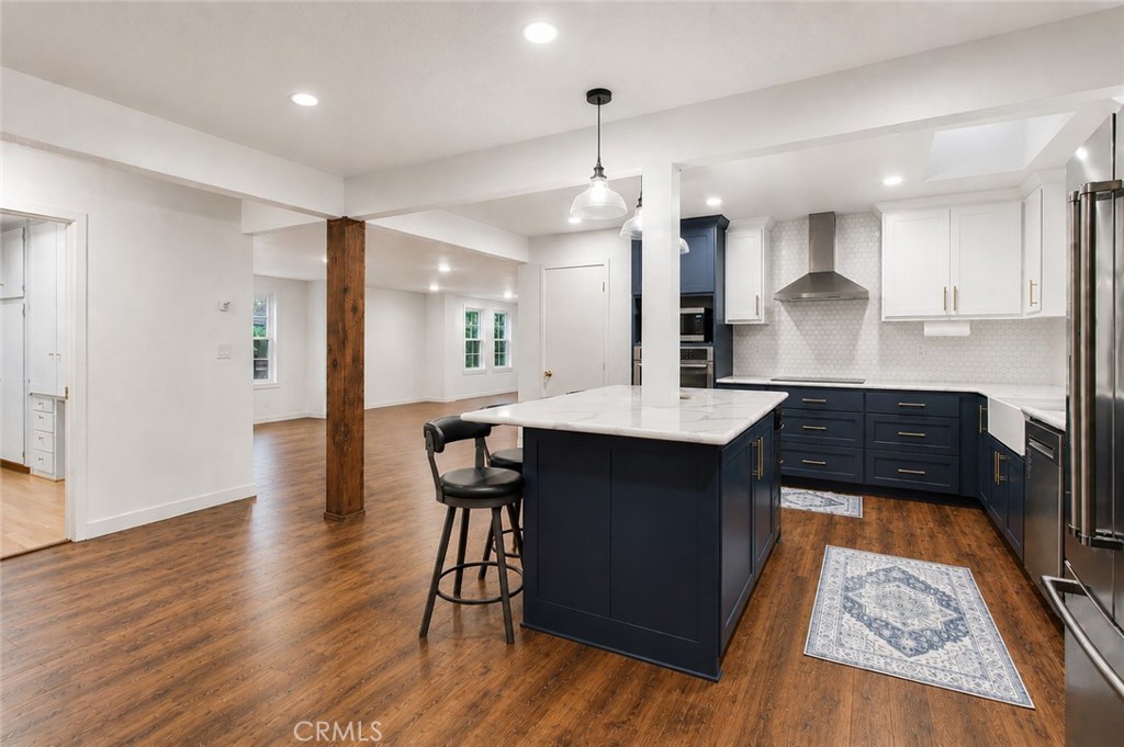1908 Chelwood Way Modesto, CA 95355 - Photo 7 of 54 a kitchen with stainless steel appliances granite countertop a stove a sink a refrigerator and a dining table with wooden floor
