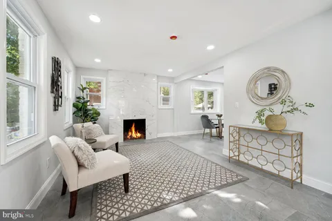 a living room with furniture a fireplace and a table