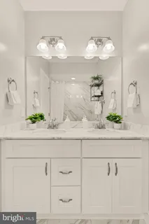 a bathroom with vanity and mirror