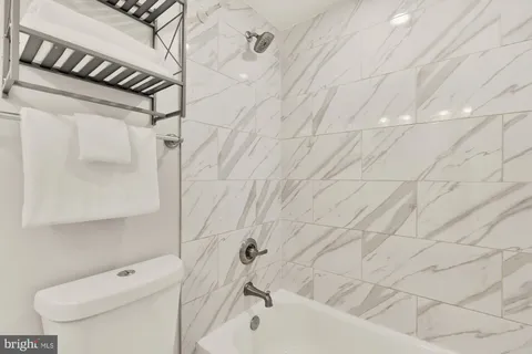 a bathroom with a toilet and a tub