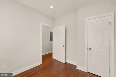 an empty room with wooden floor