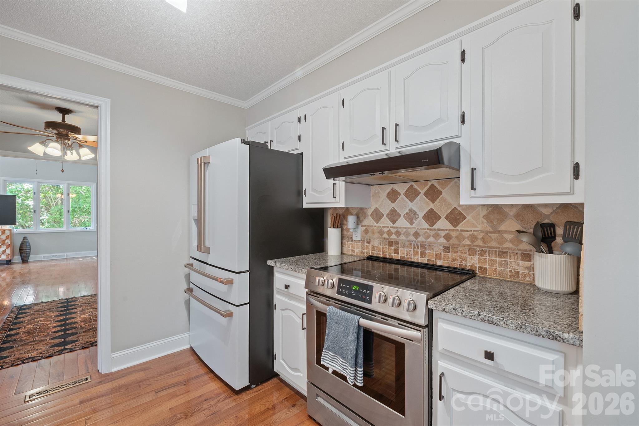 19017 Kailua Circle Tega Cay, SC 29708 - Photo 12 of 46 a kitchen with refrigerator a stove and cabinets