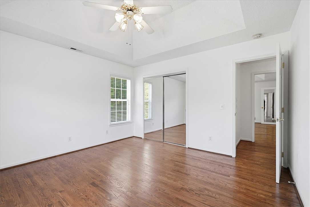 1052 Madden Bridge Road Central, SC 29630 - Photo 5 of 50 Gleaming hardwood floors run throughout this bedroom featuring a vaulted ceiling and sliding mirrored closet doors.