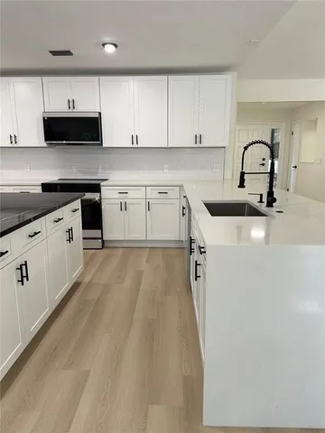 a view of a closet area with wooden floor