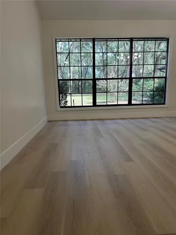 a view of a room with an empty space and a window