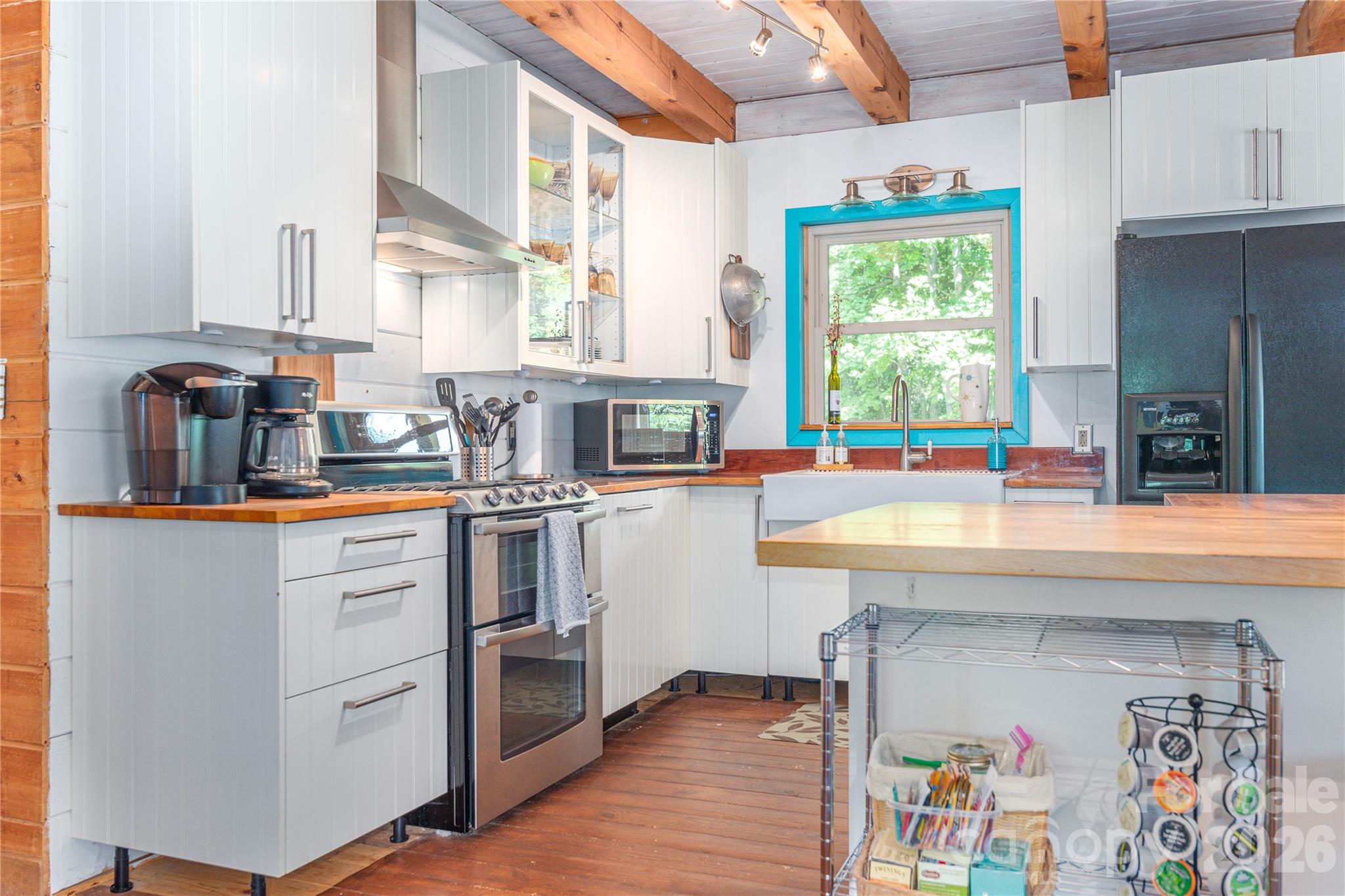 40 Shook Cove Road Leicester, NC 28748 - Photo 16 of 48 a kitchen with stainless steel appliances granite countertop a sink and a large window