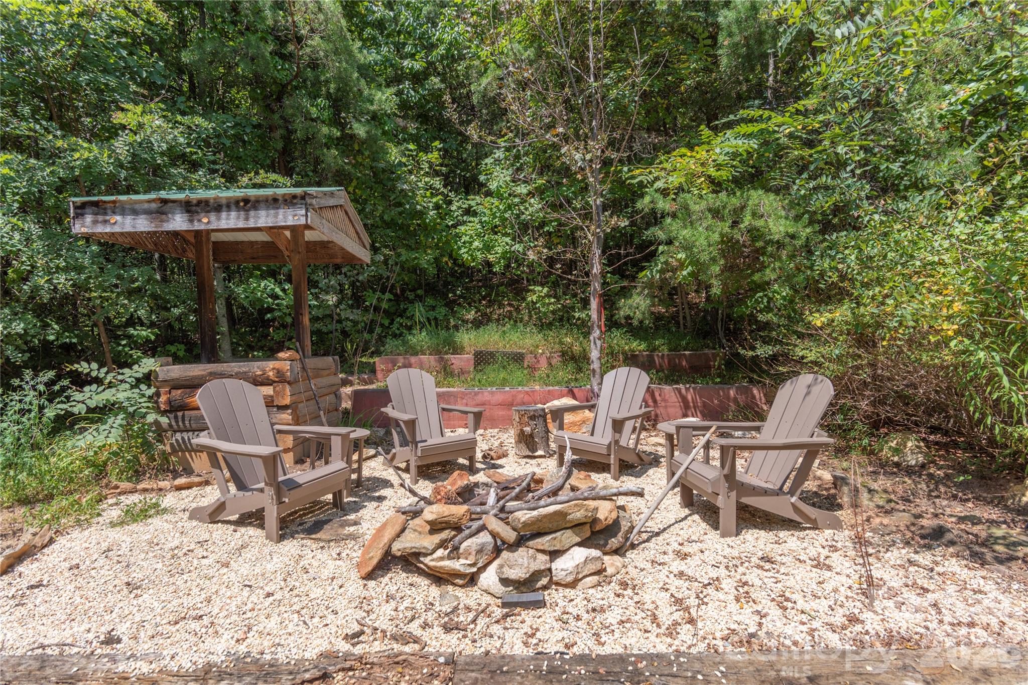 40 Shook Cove Road Leicester, NC 28748 - Photo 47 of 48 a view of backyard with table and chairs under an umbrella