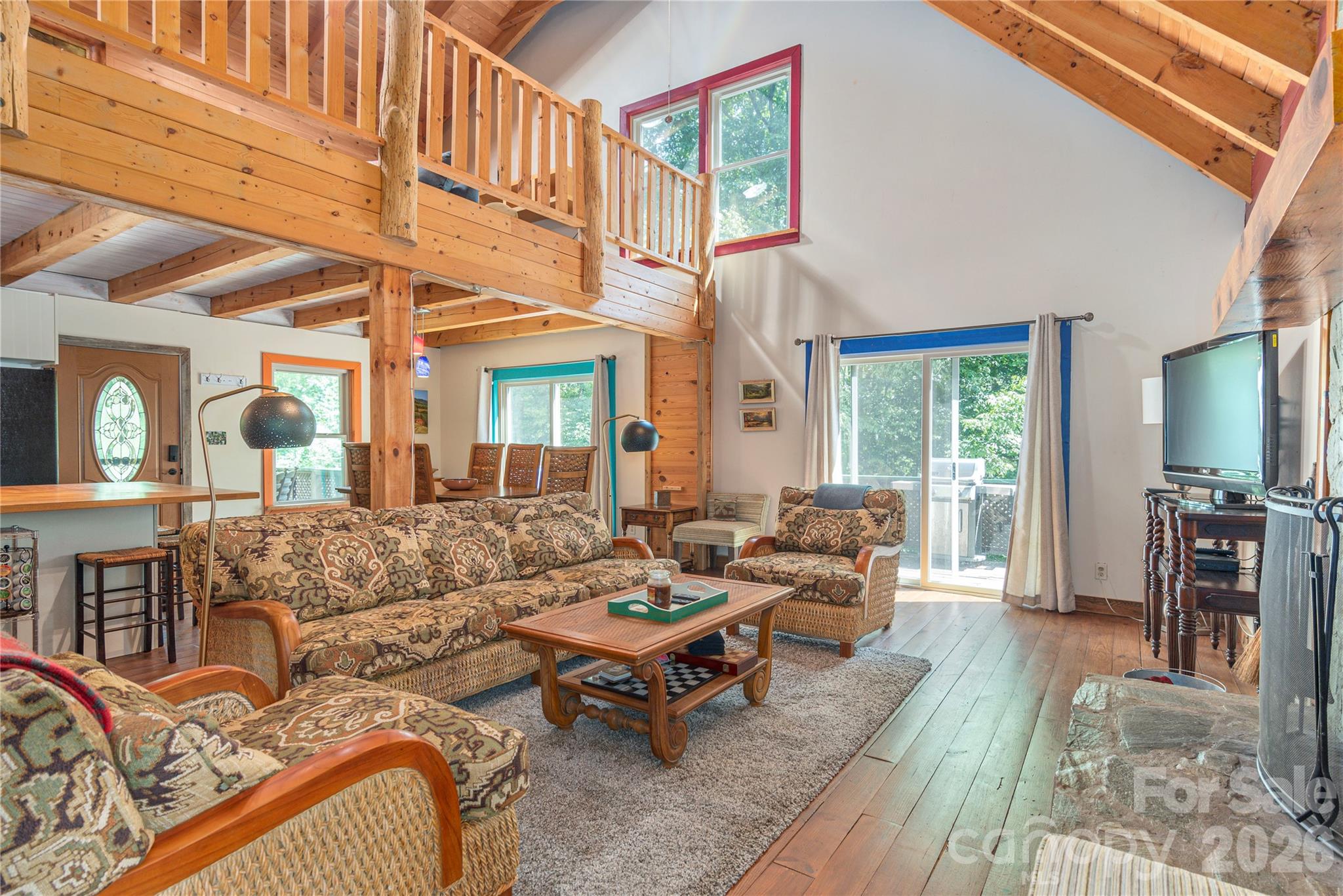 40 Shook Cove Road Leicester, NC 28748 - Photo 7 of 48 a living room with furniture a wooden floor and a large window