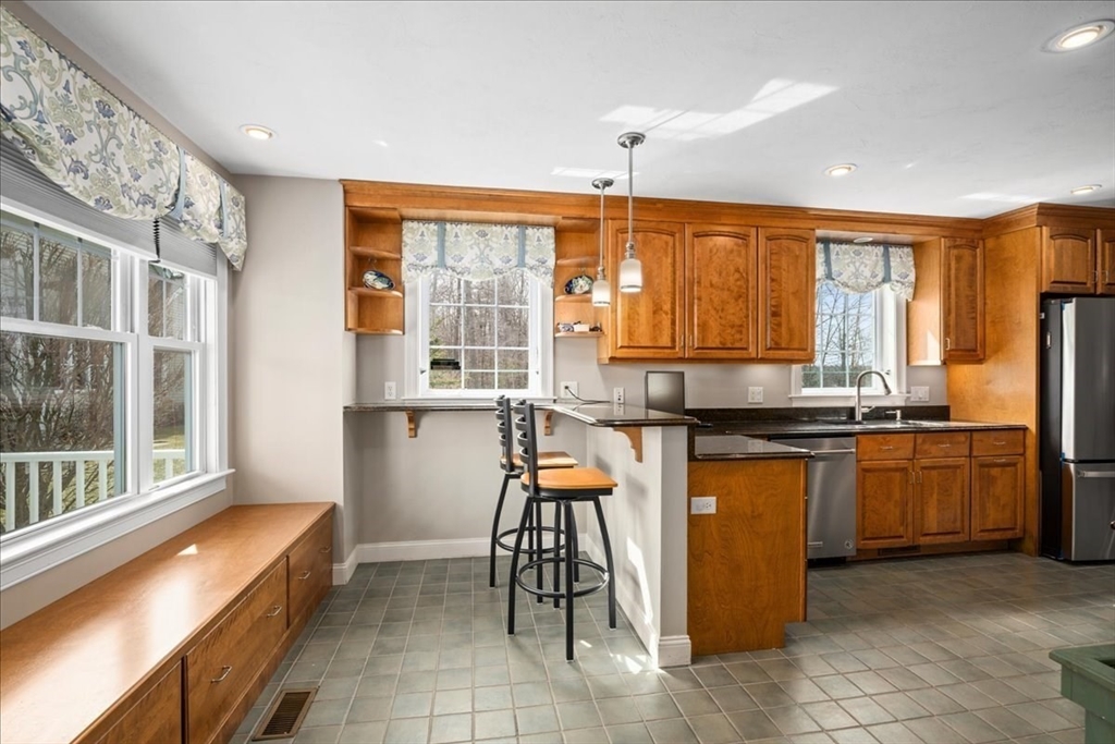 7 Primmett Lane, Unit 7 Worcester, MA 01609 - Photo 6 of 38 a kitchen with stainless steel appliances granite countertop a stove and a refrigerator