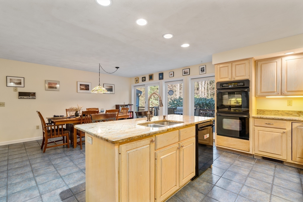 18 Fox Run Road Sudbury, MA 01776 - Photo 11 of 41 a kitchen with stainless steel appliances granite countertop a stove and a refrigerator