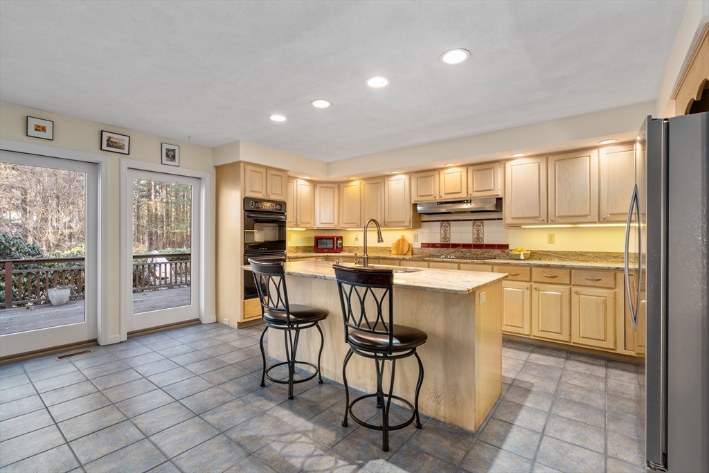 18 Fox Run Road Sudbury, MA 01776 - Photo 12 of 41 a kitchen with stainless steel appliances granite countertop a refrigerator and cabinets