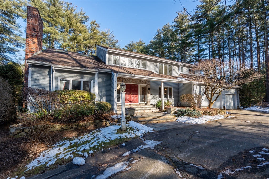 18 Fox Run Road Sudbury, MA 01776 - Photo 2 of 41 a front view of a house with garden and trees