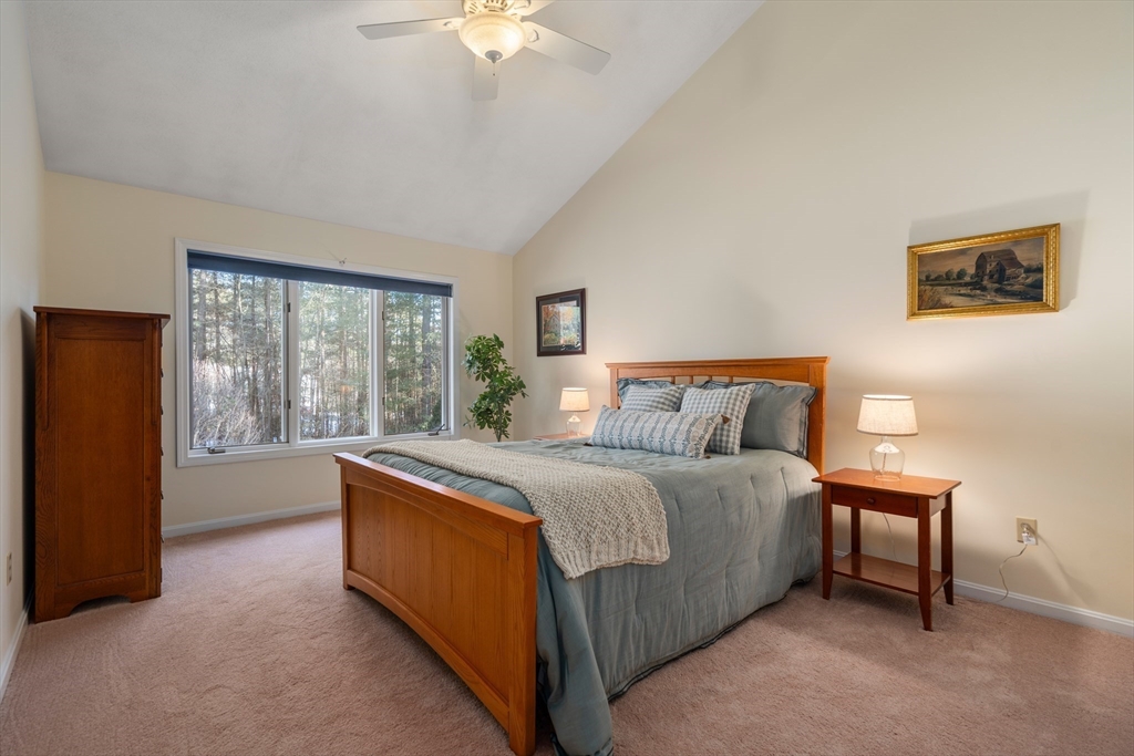 18 Fox Run Road Sudbury, MA 01776 - Photo 23 of 41 a large bedroom with a bed and a chandelier