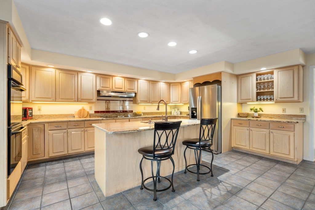18 Fox Run Road Sudbury, MA 01776 - Photo 10 of 41 a kitchen with kitchen island granite countertop cabinets and chairs