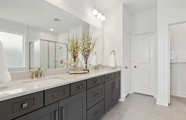 a bathroom with a double vanity sink and a mirror