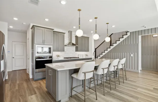 a kitchen with a table chairs and a chandelier