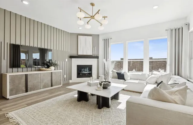 a living room with furniture a fireplace and a table