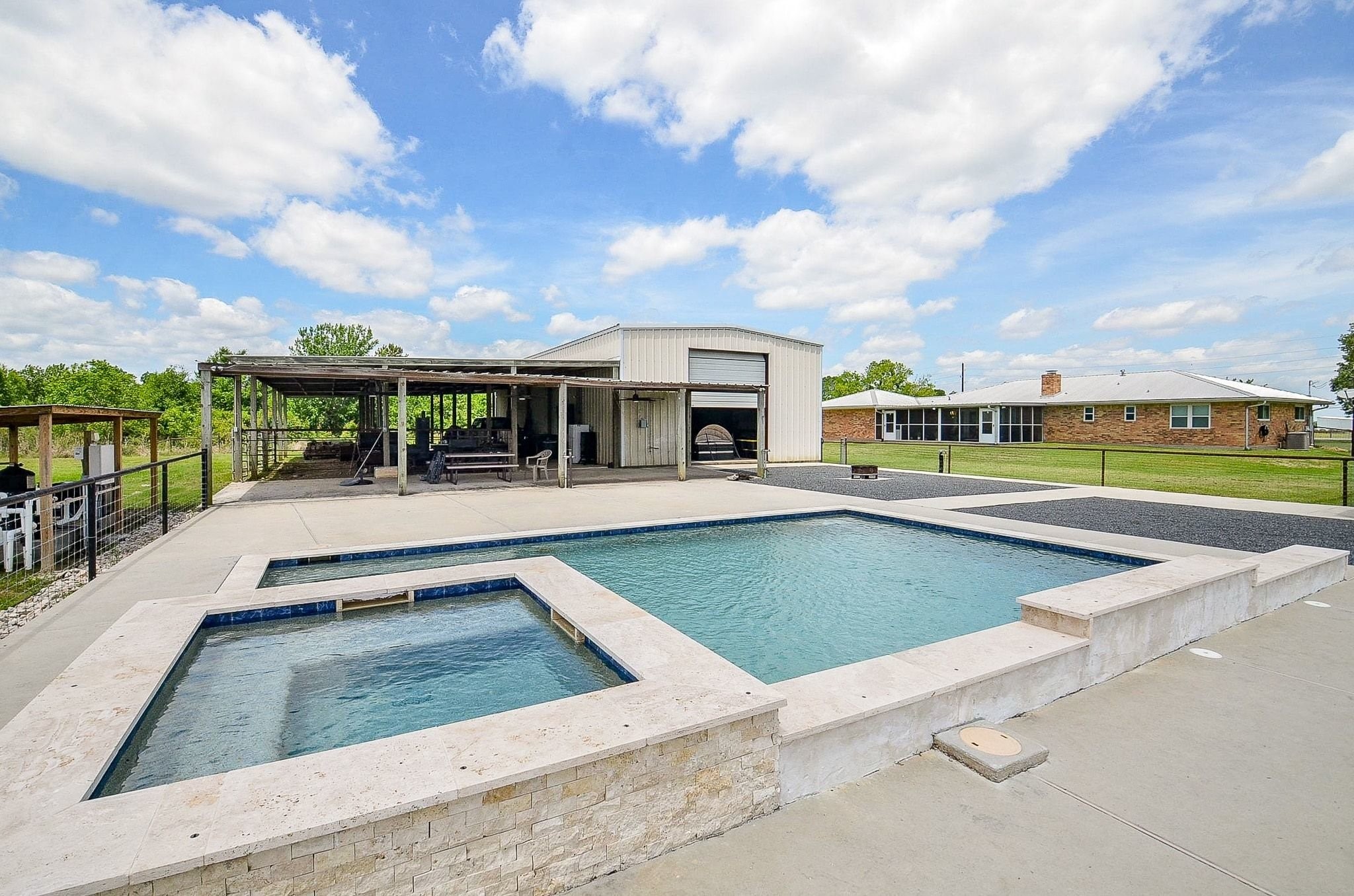 2500 County Road 62 Rosharon, TX 77583 - Photo 1 of 48 a view of a swimming pool with a lawn chairs and floor to ceiling window