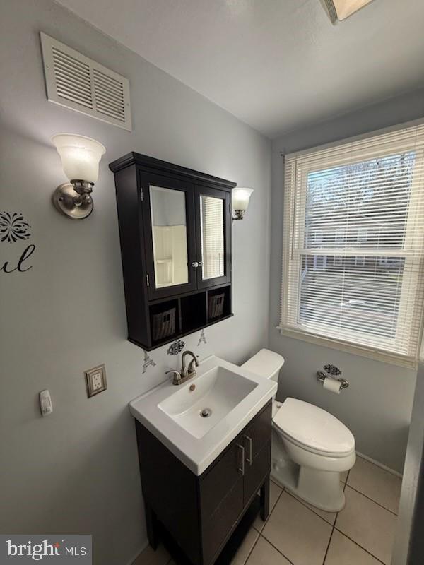 49 Briarwood Road Baltimore, MD 21228 - Photo 7 of 9 a bathroom with a toilet sink and mirror