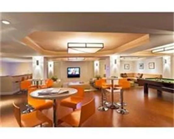 a living room with furniture a flat screen tv and a table