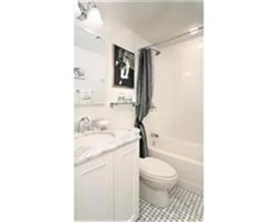 a bathroom with a toilet a sink and a mirror