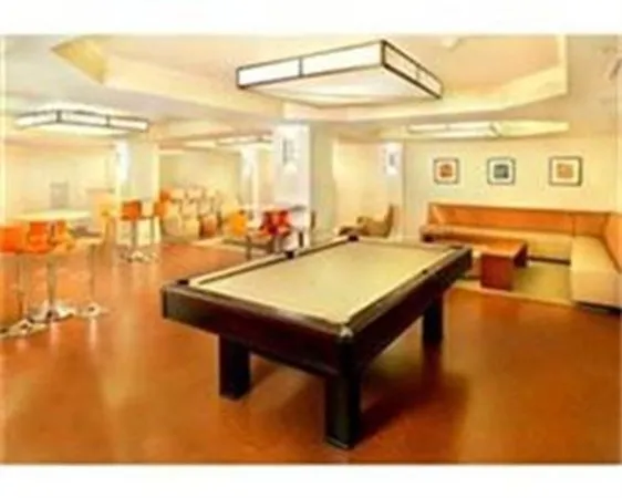 a room with pool table and windows