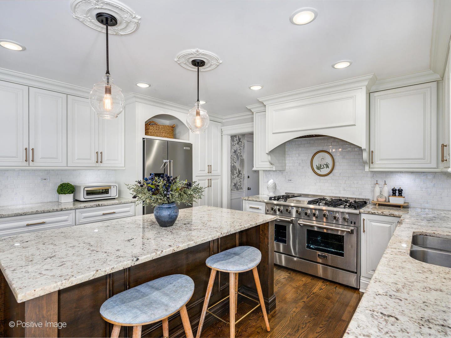 1026 Elmdale Road Glenview, IL 60025 - Photo 13 of 38 a kitchen with a stove a chandelier and wooden floor