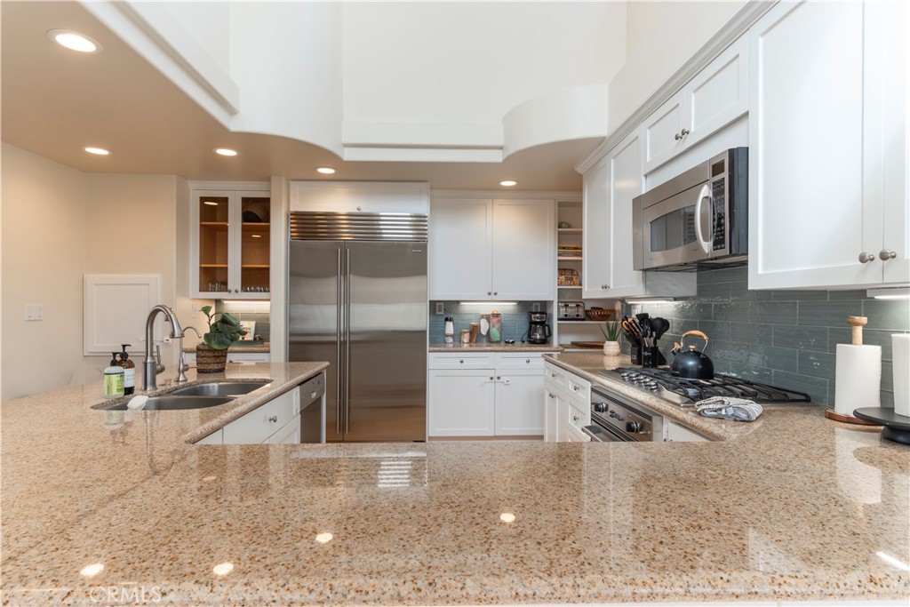 62 62nd Place Long Beach, CA 90803 - Photo 16 of 55 a kitchen with granite countertop a sink stainless steel appliances and cabinets