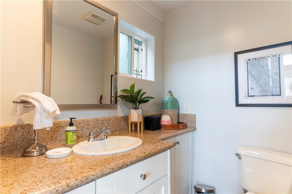 62 62nd Place Long Beach, CA 90803 - Photo 21 of 55 a bathroom with a granite countertop sink and a mirror