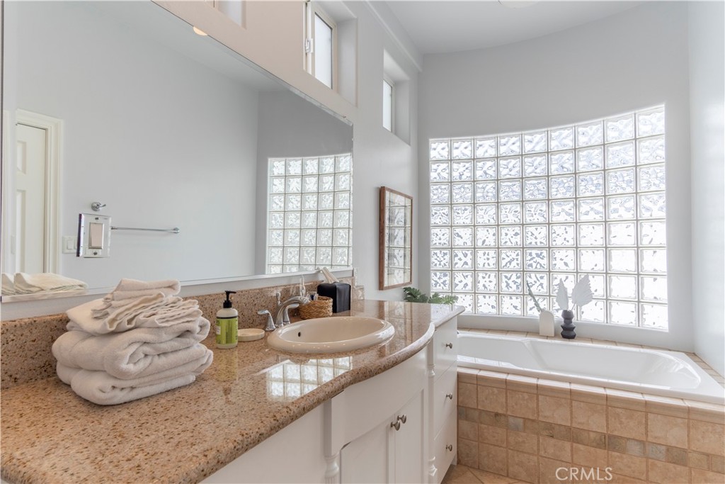 62 62nd Place Long Beach, CA 90803 - Photo 25 of 55 a spacious bathroom with a granite countertop tub and a large window