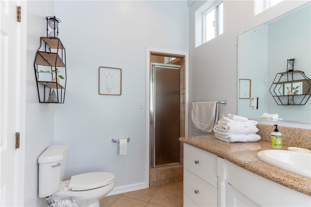 62 62nd Place Long Beach, CA 90803 - Photo 26 of 55 a bathroom with a granite countertop sink mirror vanity and toilet