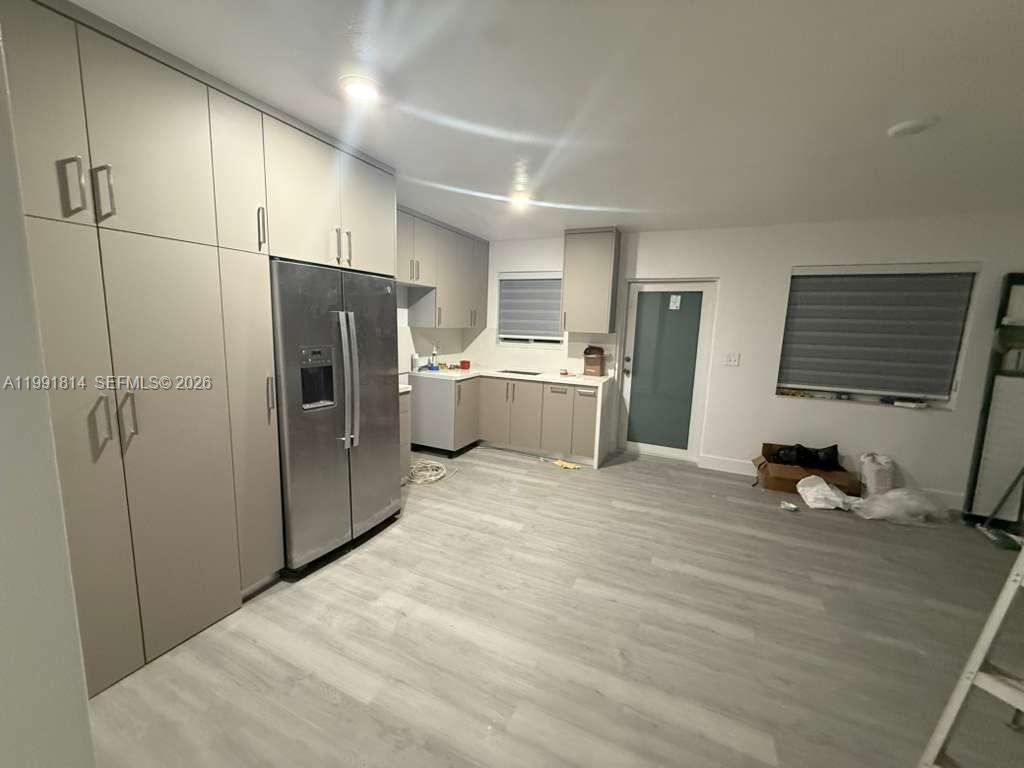 225 Southwest 76th Court, Unit 225 Miami, FL 33144 - Photo 2 of 7 a room with a bed and a refrigerator