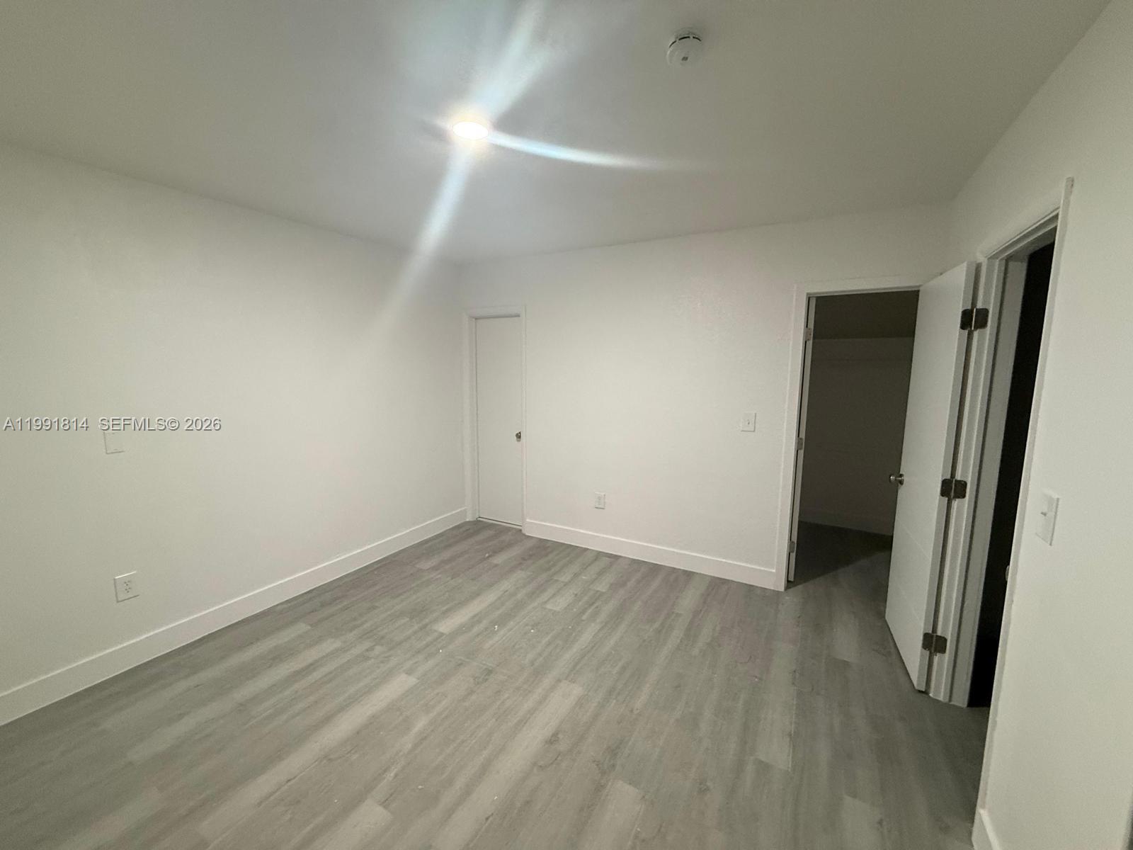 225 Southwest 76th Court, Unit 225 Miami, FL 33144 - Photo 5 of 7 wooden floor in an empty room