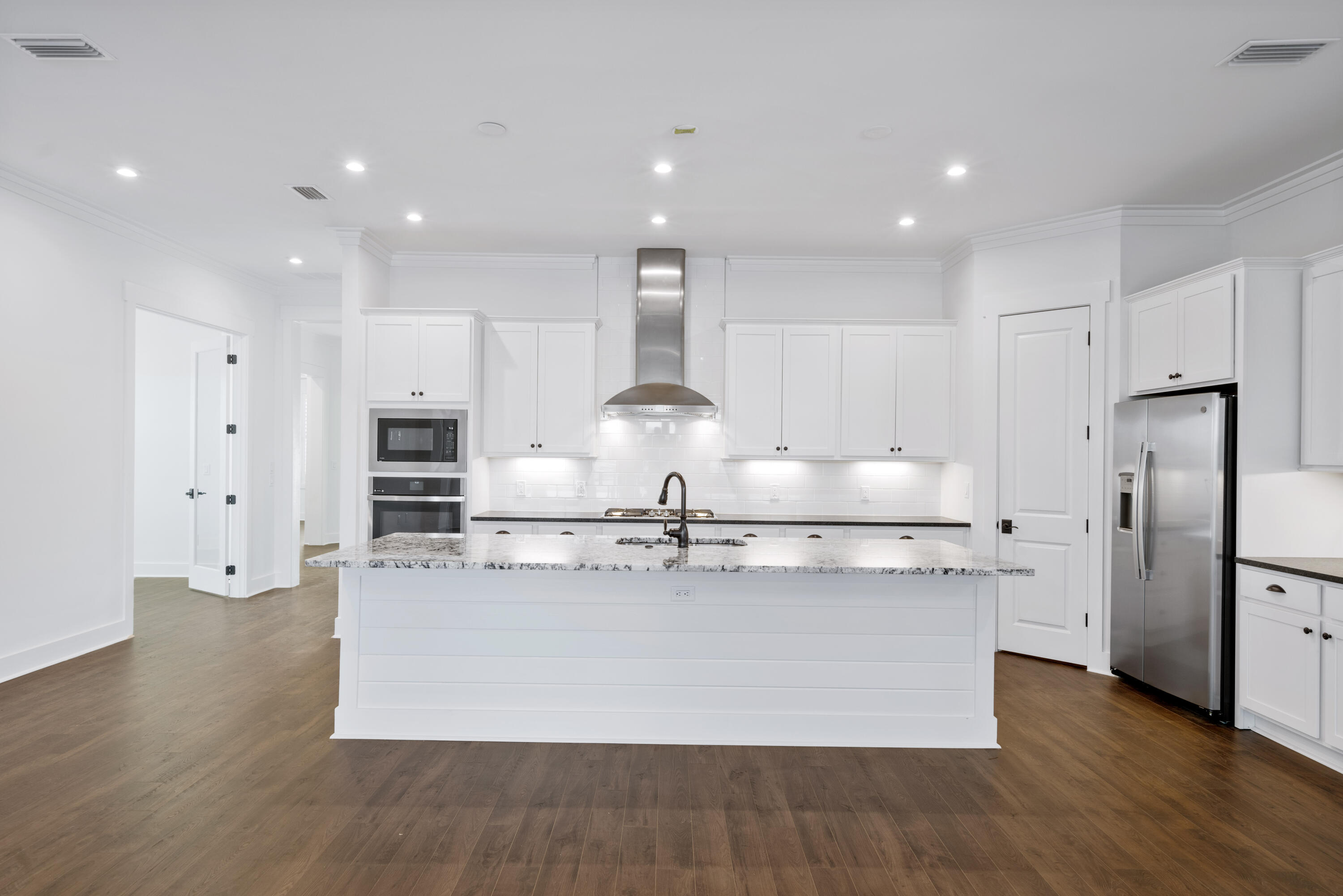 95 Ravine Rd Inlet Beach Inlet Beach, FL 32461 - Photo 17 of 42 a large kitchen with stainless steel appliances kitchen island a large counter top and wooden floors