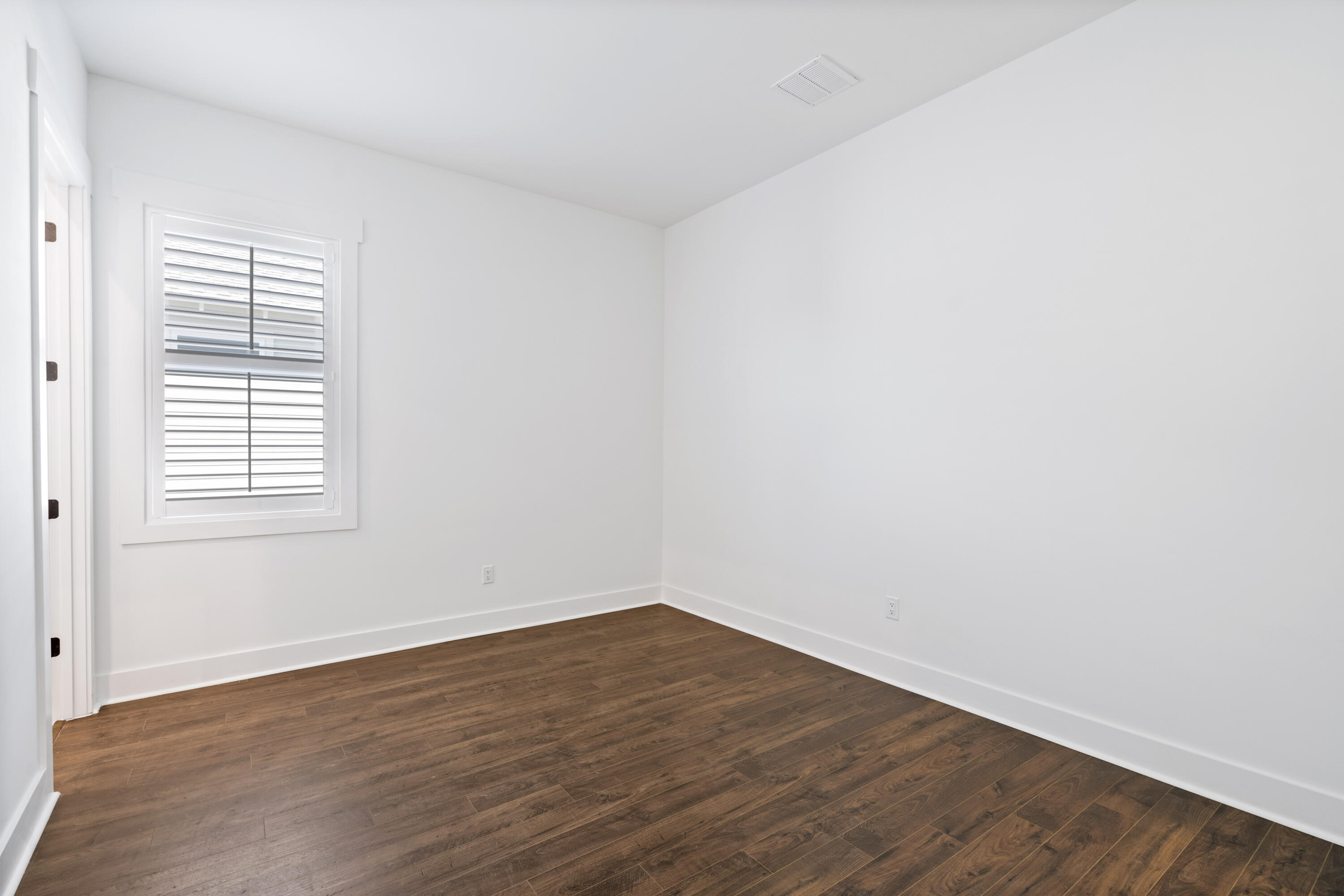 95 Ravine Rd Inlet Beach Inlet Beach, FL 32461 - Photo 31 of 42 an empty room with wooden floor and windows